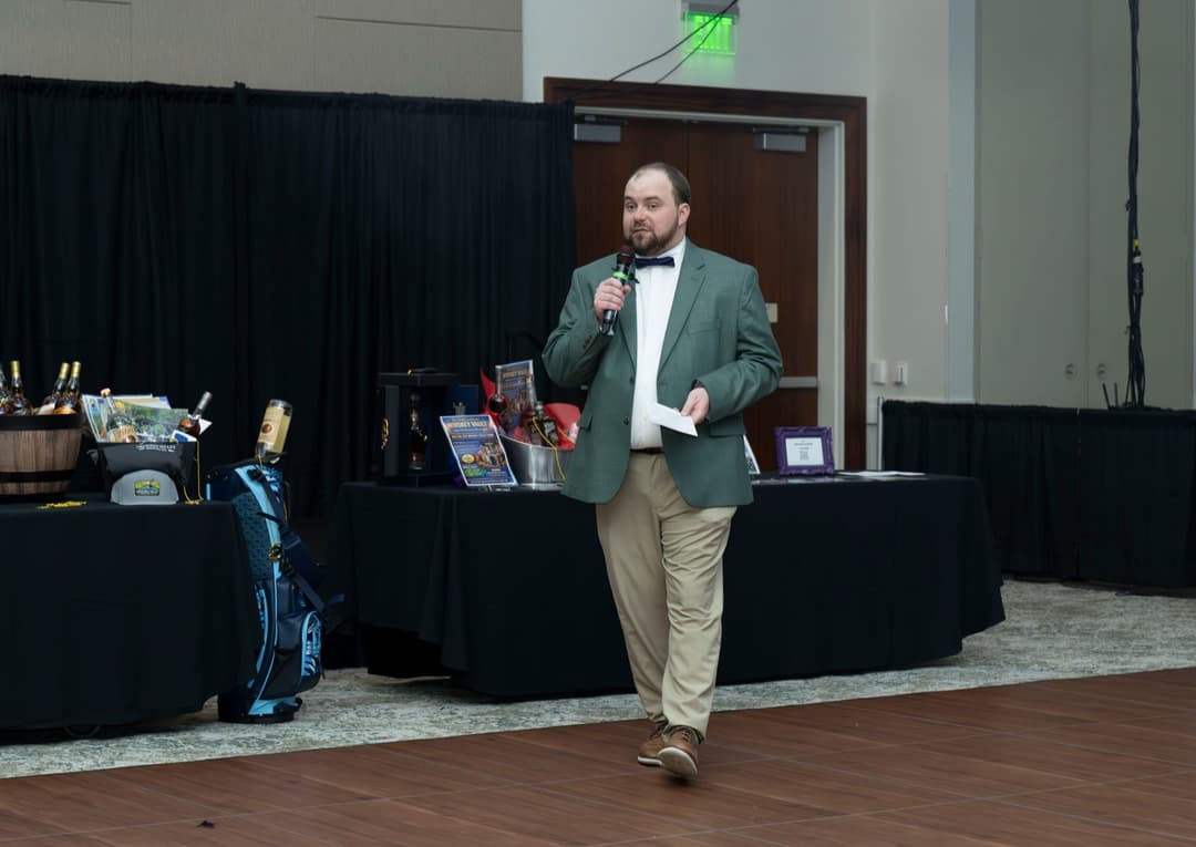 Logan Lewis emceeing a fundraiser event